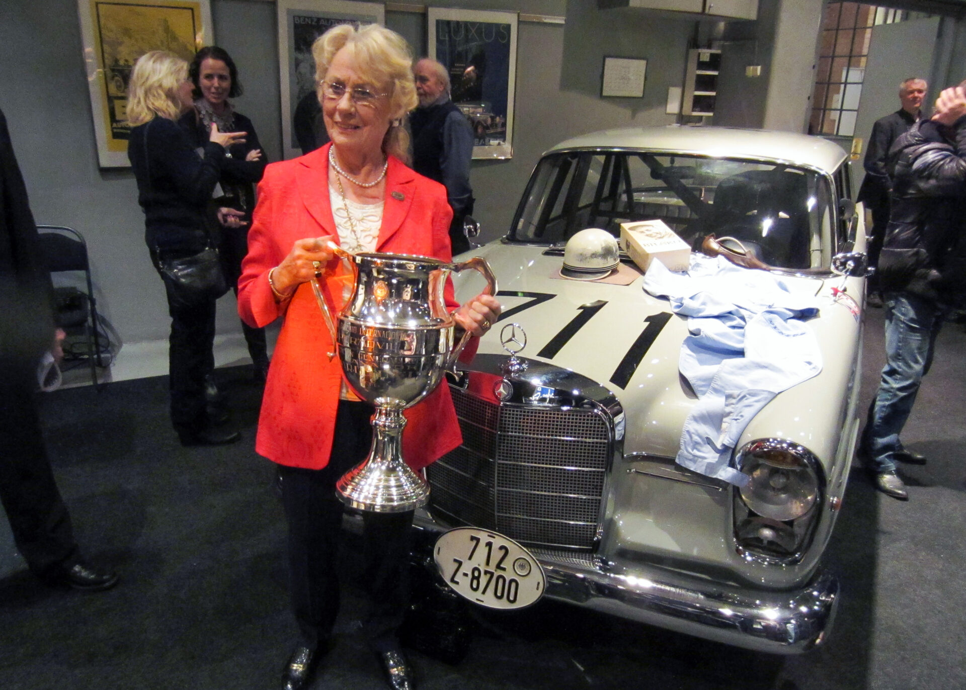 Ewy Rosqvist-von Korff hyllades 2012 på Nacka Strand i Stockholm i samband med 50-års jubileet av vinsten i Argentina. Ewy i röd dräkt hållandes en stor pokal med tävlingsbilen, en ljusbeige Mercedes-Benz 220 SEb från 1960, i bakgrunden. På huven hennes tävlingskläder.